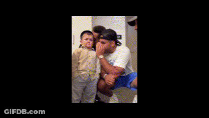 Man Holding Child With Another Man Behind GIF