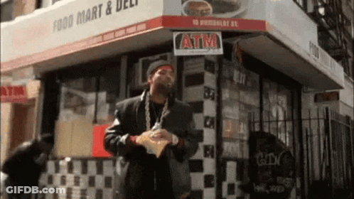 Man Holding Chips Outside Food Mart GIF