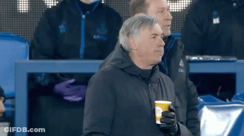 Man Holding Coffee Cup In Stadium GIF