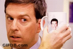 Man Holding Coffee Mug With Face GIF