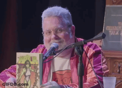 Man Holding Comic Book At Microphone Chicago Talk GIF