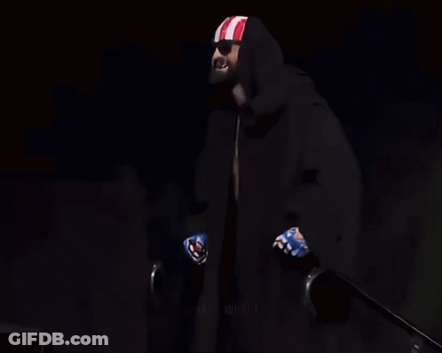 Man Holding Coors Light, Black Cape, Red-White-Blue Headband GIF
