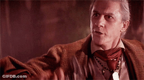 Man Holding Cross In Dark Room GIF