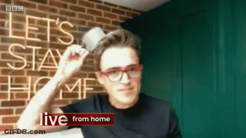 Man Holding Cup In Front Of Let Stay Home Sign GIF