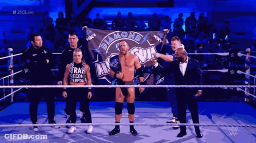 Man Holding Diamond Flag In Wrestling Ring GIF
