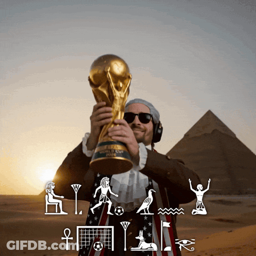 Man Holding FIFA World Cup Trophy In Front Of Pyramids GIF