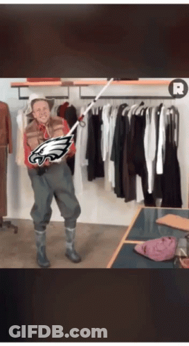Man Holding Fishing Rod With Eagles Logo GIF