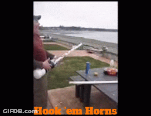 Man Holding Fishing Rod With Hook Em Horns GIF