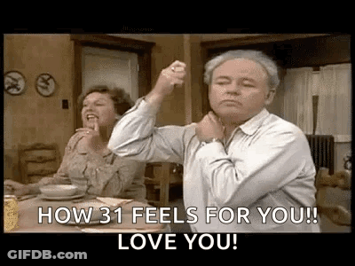Man Holding Fist In Air At Table With Woman GIF