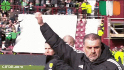 Man Holding Fist In Front Of Scoreboard GIF
