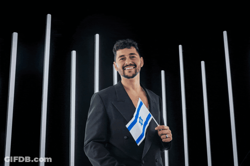 Man Holding Flag Noam Bettan Stands With Israel Banner GIF