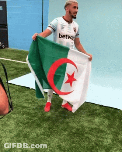 Man Holding Flag With Red Star And Green Crescent Moon GIF