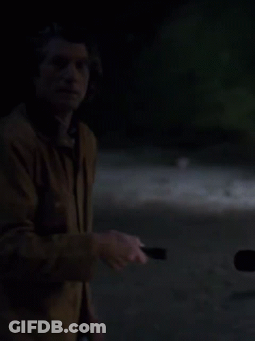 Man Holding Flashlight In Dark GIF
