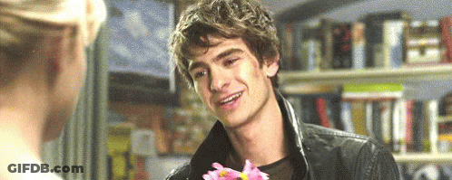 Man Holding Flower In Front Of Woman Smiling GIF