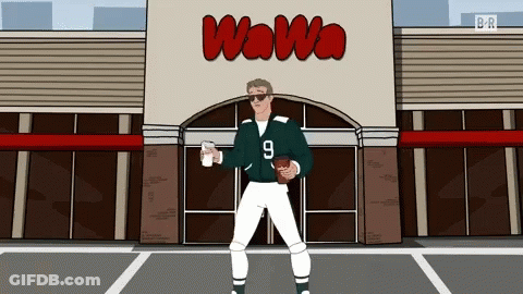 Man Holding Football In Front Of Wawa GIF
