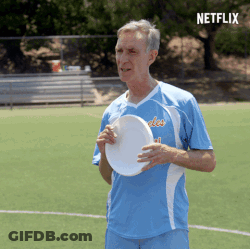 Man Holding Frisbee On Field With Netflix Logo GIF