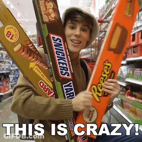 Man Holding Giant Snickers And Reese's Bars GIF