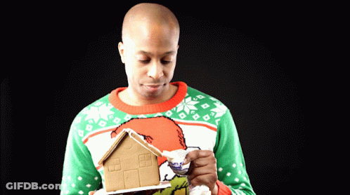Man Holding Gingerbread House GIF