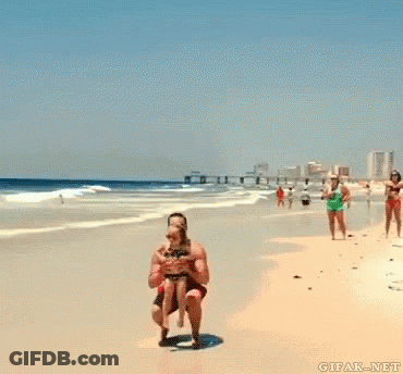 Man Holding Girl Up In The Air On Beach GIF