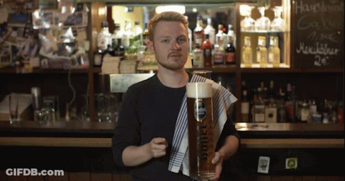 Man Holding Glass Of Beer That Says Sriel GIF