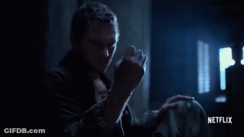 Man Holding Glowing Netflix Logo GIF