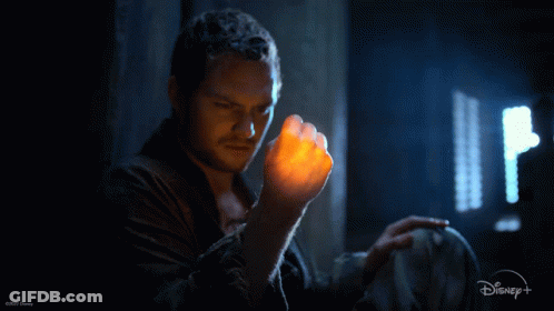 Man Holding Glowing Object With Disney Logo GIF