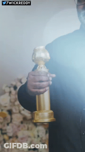 Man Holding Golden Globes Behind 7Wickreddy Sticker GIF