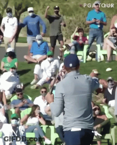 Man Holding Golf Club In Front Of Crowd GIF