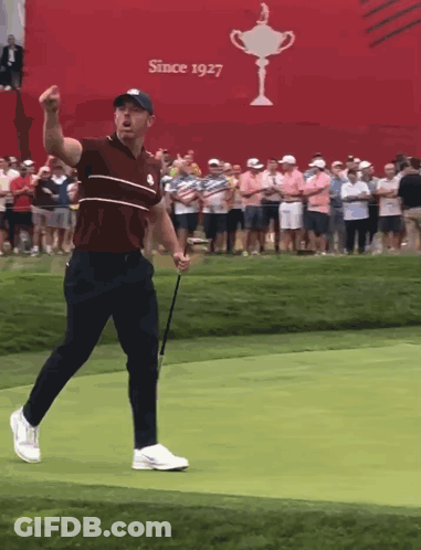 Man Holding Golf Club In Front Of Since 1927 Sign GIF