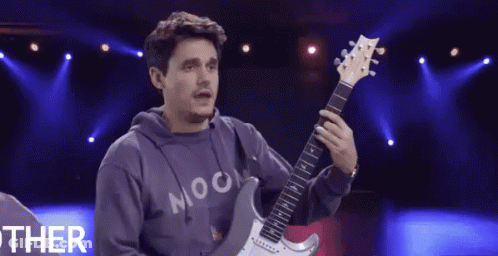 Man Holding Guitar Wearing Moon Shirt GIF