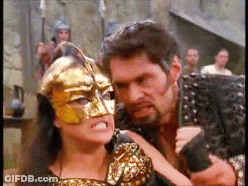 Man Holding Gun And Woman Wearing Mask GIF
