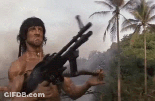 Man Holding Gun By River In Jungle GIF