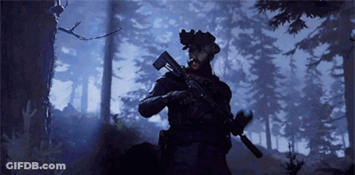 Man Holding Gun In Dark Forest At Night GIF