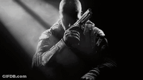 Man Holding Gun In Dark Room GIF
