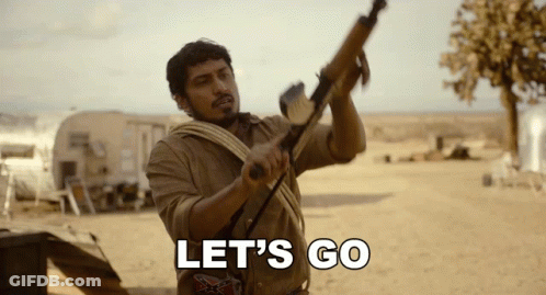 Man Holding Gun In Desert Saying Let's Go GIF