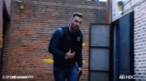 Man Holding Gun In Front Of Brick Wall Chicagopd GIF