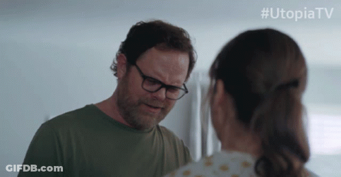 Man Holding Gun In Front Of Door With UtopiaTV GIF