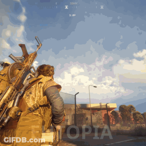 Man Holding Gun In Front Of Etopia Building GIF