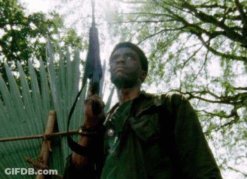 Man Holding Gun In Front Of Fan GIF