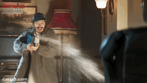 Man Holding Gun In Front Of Fast And Furious Poster GIF