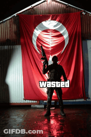 Man Holding Gun In Front Of Wasted Flag GIF