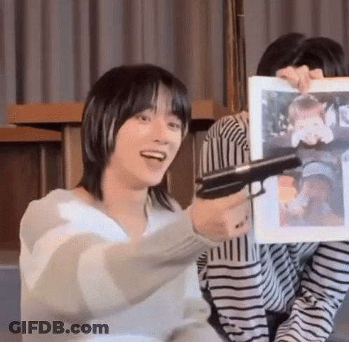 Man Holding Gun In Front Of Woman Picture GIF