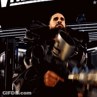 Man Holding Gun In Front Of Wrestleview Sign GIF