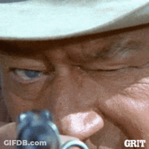 Man Holding Gun Saying Grit GIF