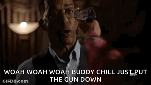 Man Holding Gun Saying Woah Chill GIF