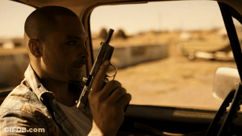 Man Holding Gun Sitting In Car GIF