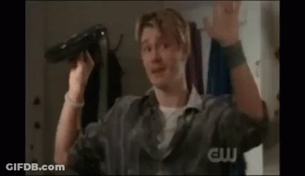 Man Holding Hair Dryer Making Funny Face GIF