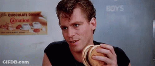 Man Holding Hamburger In Front Of Boys Sign GIF