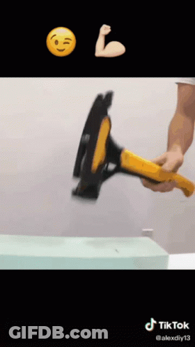 Man Holding Hammer In Front Of Smiley Face GIF