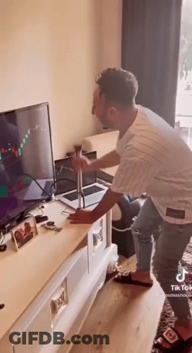 Man Holding Hammer In Front Of TV GIF
